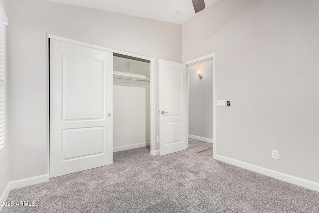 unfurnished bedroom featuring a closet, carpet flooring, and baseboards