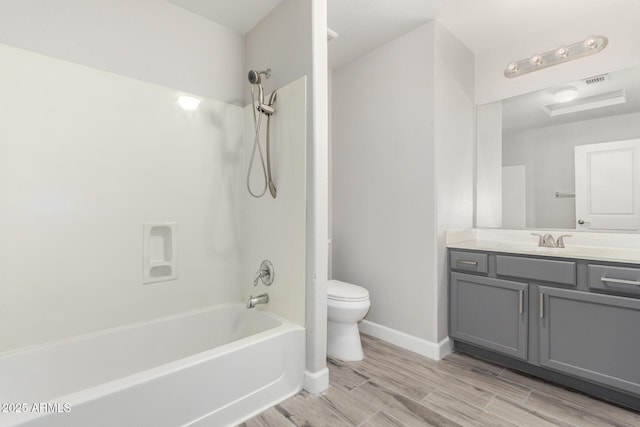 full bathroom featuring toilet, washtub / shower combination, wood tiled floor, vanity, and baseboards