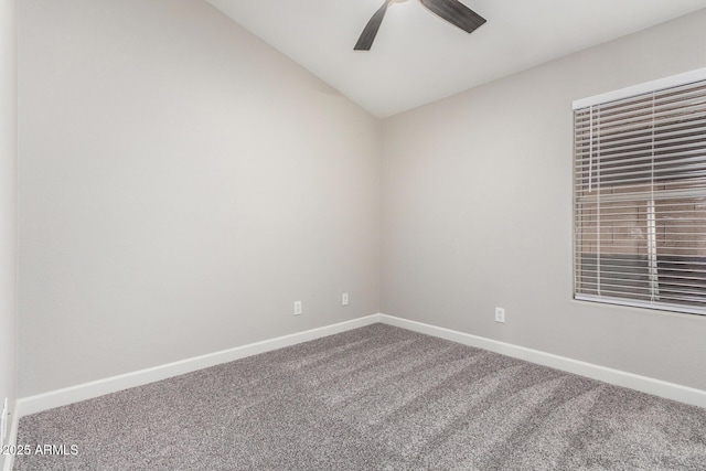 spare room featuring lofted ceiling, ceiling fan, baseboards, and carpet flooring