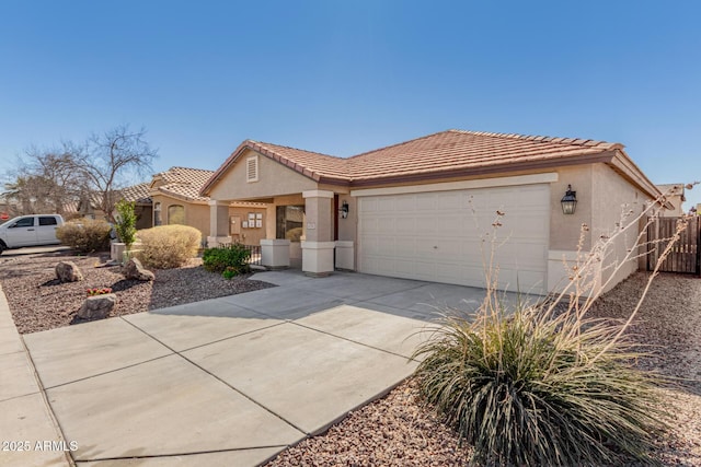 view of front of property featuring stucco siding, concrete driveway, fence, a garage, and a tiled roof