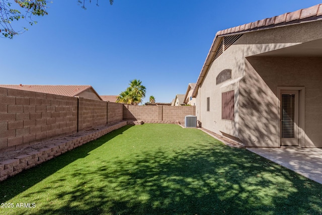 view of yard with a fenced backyard and central air condition unit