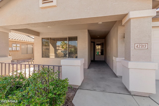 view of exterior entry featuring stucco siding