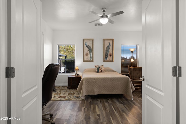 bedroom featuring ceiling fan and dark hardwood / wood-style floors