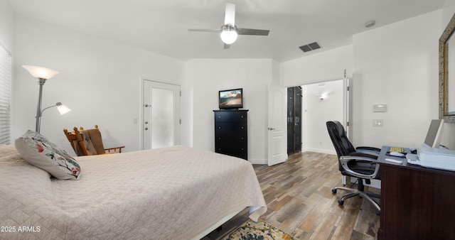 bedroom with lofted ceiling, dark wood-type flooring, and ceiling fan