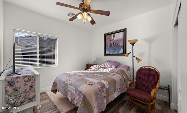 bedroom with dark wood-type flooring and ceiling fan