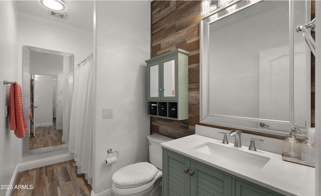 bathroom with vanity, wood-type flooring, a shower with shower curtain, and toilet