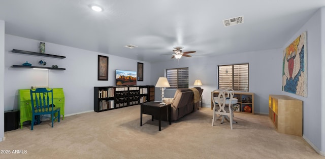 living room featuring ceiling fan and light colored carpet