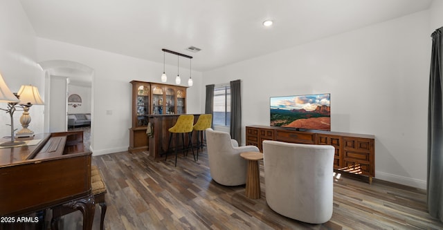 interior space featuring indoor bar and dark hardwood / wood-style floors