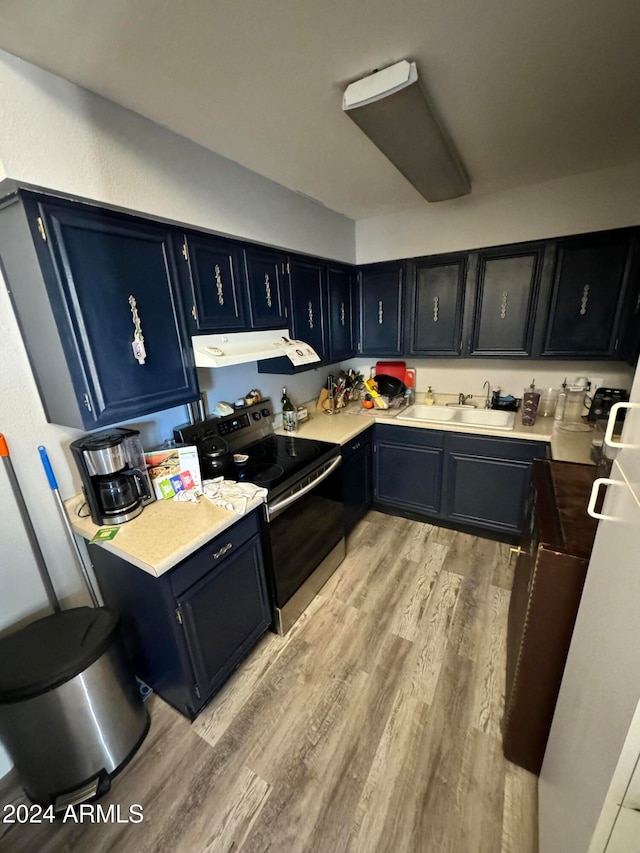 kitchen with stainless steel electric range oven, light hardwood / wood-style flooring, and sink