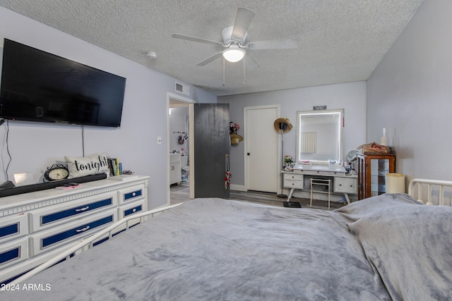 bedroom with ceiling fan and a textured ceiling