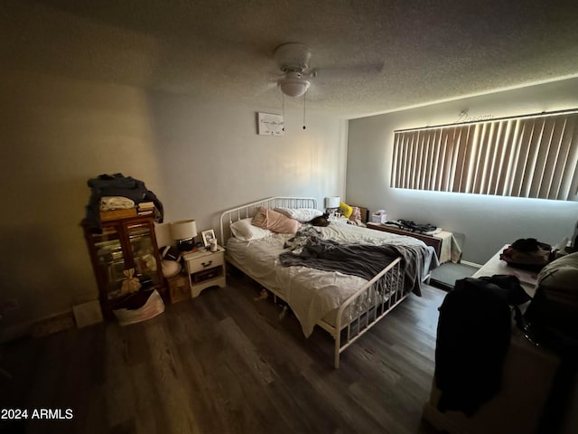 bedroom featuring a textured ceiling, ceiling fan, and dark hardwood / wood-style floors