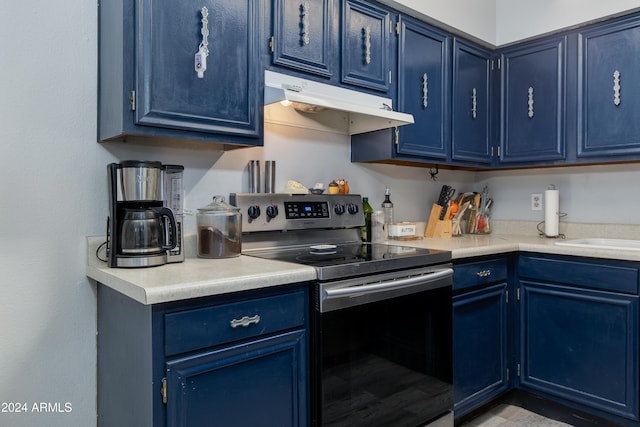 kitchen with blue cabinetry and stainless steel electric stove