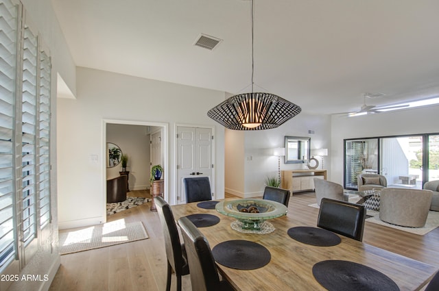 dining room with ceiling fan and light wood-type flooring
