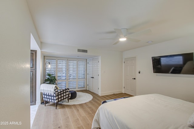 bedroom with ceiling fan and light wood-type flooring