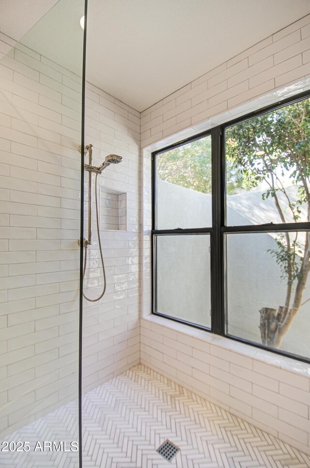 bathroom with tiled shower