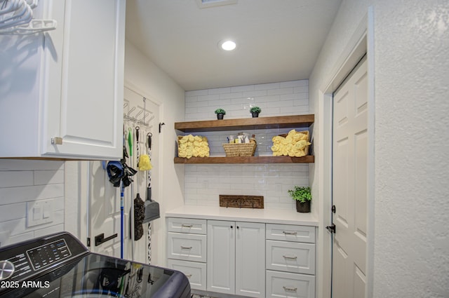 laundry area with cabinets and washer / clothes dryer