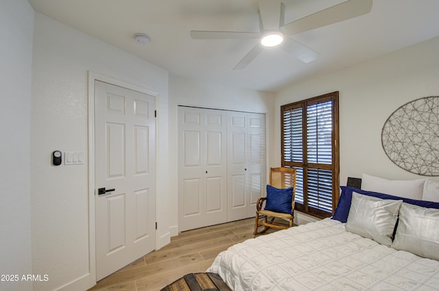 bedroom with a closet, ceiling fan, and light hardwood / wood-style flooring