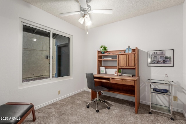 carpeted home office featuring ceiling fan and a textured ceiling