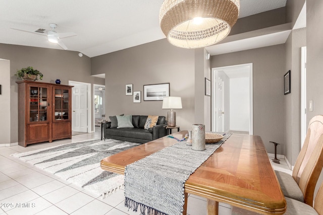 living room with lofted ceiling, light tile patterned floors, and ceiling fan