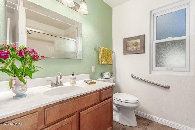 bathroom featuring tile patterned flooring, vanity, toilet, and walk in shower