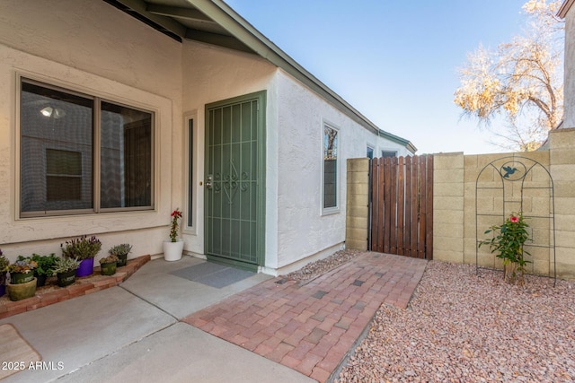 view of exterior entry with a patio