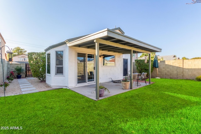 back of property with a patio and a yard