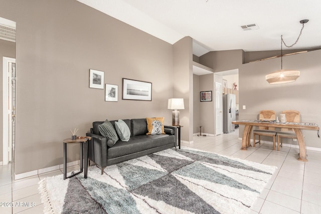 living room featuring light tile patterned floors and vaulted ceiling