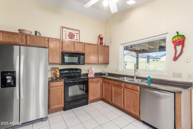 kitchen featuring sink, light tile patterned floors, black appliances, and ceiling fan