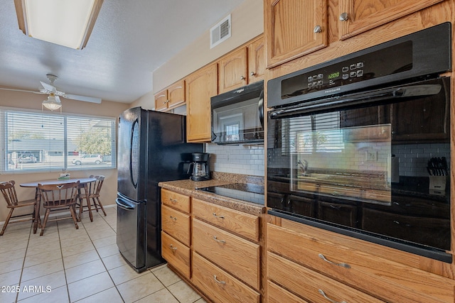 kitchen featuring tasteful backsplash, light tile patterned floors, ceiling fan, and black appliances