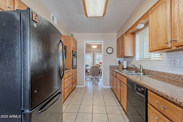 kitchen with light tile patterned flooring, sink, backsplash, and black appliances