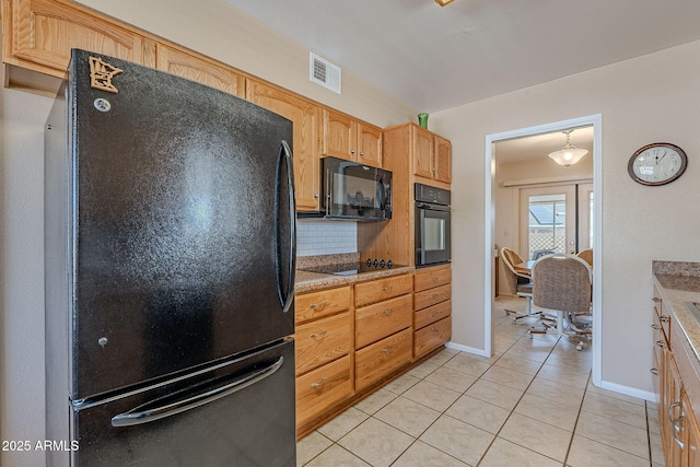 kitchen with tasteful backsplash, light tile patterned flooring, and black appliances