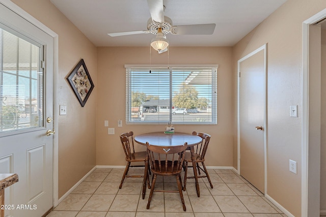 dining area featuring light tile patterned floors and ceiling fan