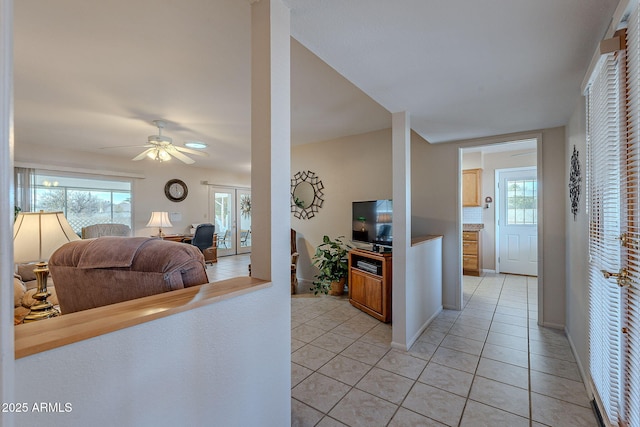 kitchen featuring ceiling fan, decorative backsplash, and light tile patterned floors