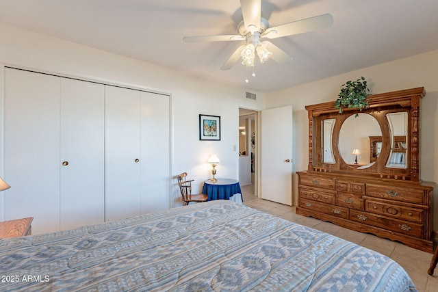 bedroom with a closet, ceiling fan, and light tile patterned flooring