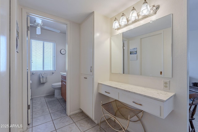 bathroom featuring tile patterned flooring, vanity, and toilet