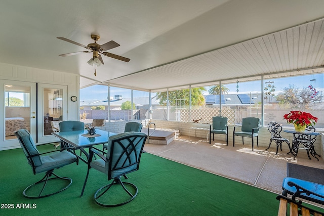 sunroom / solarium featuring french doors and ceiling fan