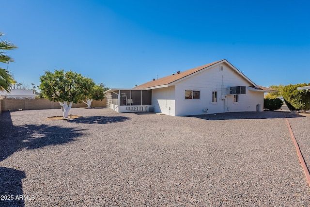 rear view of property with a sunroom