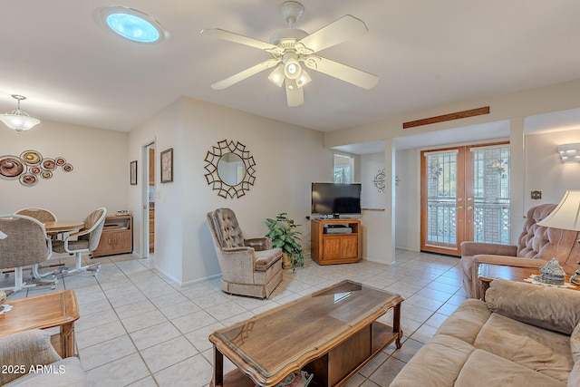 tiled living room with french doors and ceiling fan