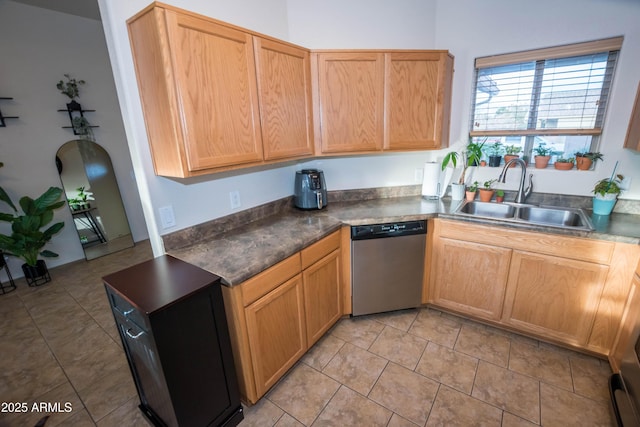 kitchen featuring sink, stainless steel dishwasher, and light tile patterned floors