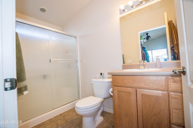 bathroom with ceiling fan, tile patterned flooring, vanity, toilet, and walk in shower