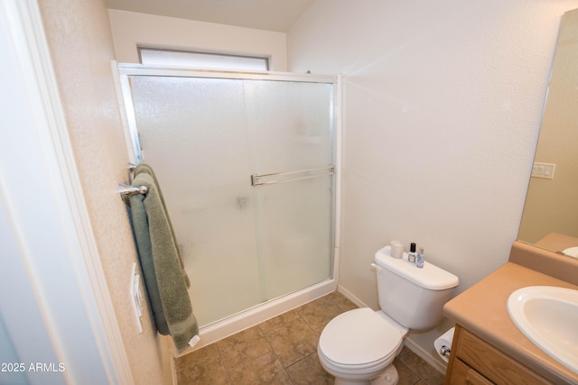 bathroom featuring tile patterned floors, vanity, toilet, and an enclosed shower