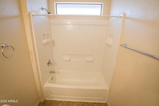 bathroom with tile patterned floors and bathtub / shower combination