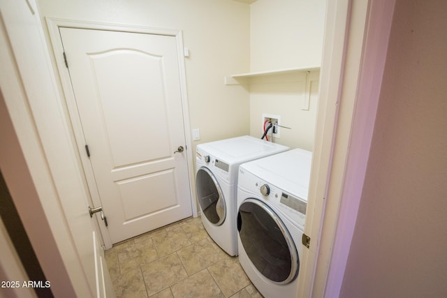 clothes washing area with washing machine and clothes dryer and light tile patterned floors