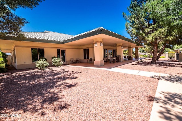 rear view of property featuring a patio area