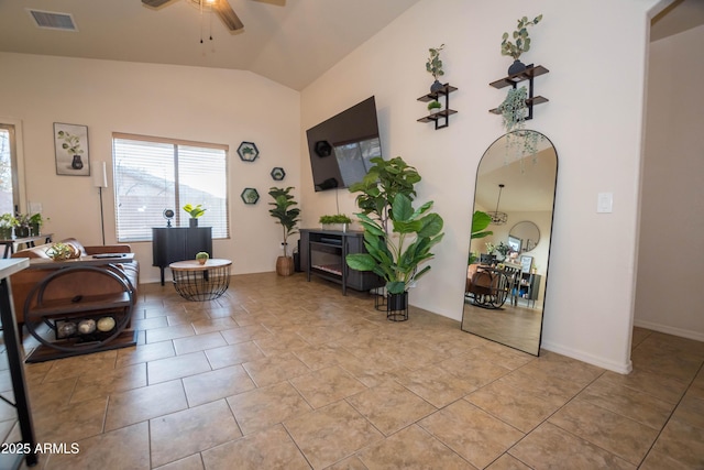 interior space with lofted ceiling, light tile patterned floors, and ceiling fan