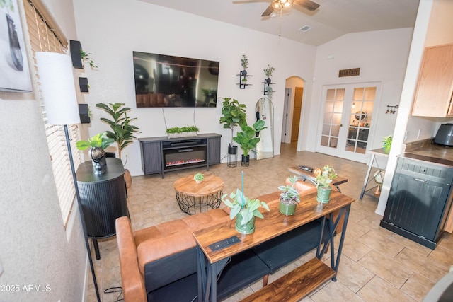 tiled dining room featuring lofted ceiling, french doors, and ceiling fan