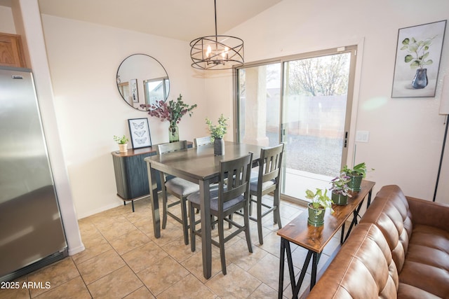 tiled dining room with vaulted ceiling and a chandelier