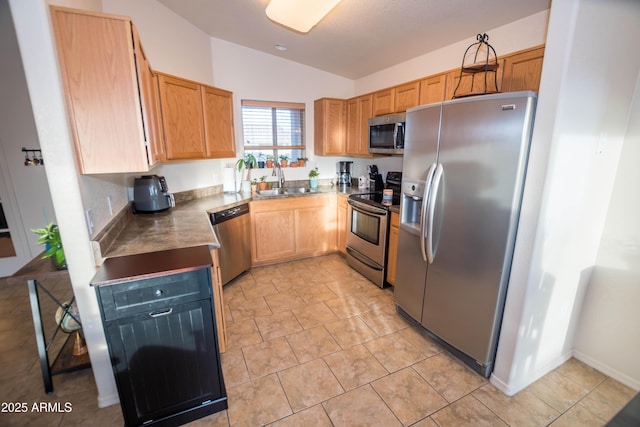 kitchen with sink, vaulted ceiling, and stainless steel appliances