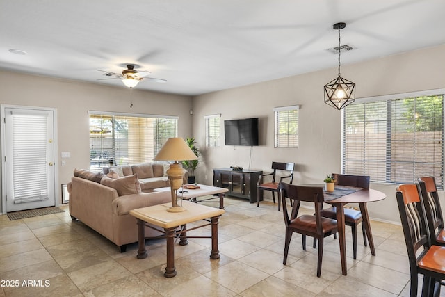 living room featuring light tile patterned floors, ceiling fan, and visible vents