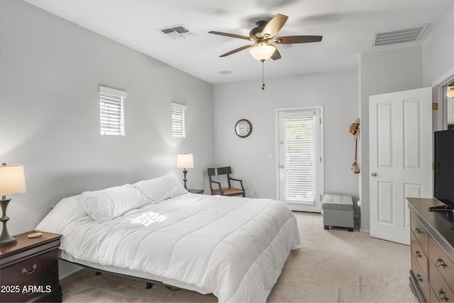 bedroom featuring ceiling fan, visible vents, and light colored carpet